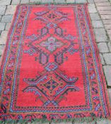 Turkey red wool carpet 169cm (inc tassels) x 90cm