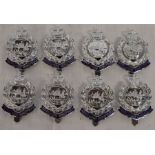 Eight unused Royal Hong Kong Police cap badges - all marked to the rear FIRMIN LONDON