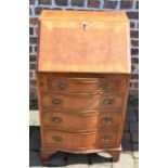 Small reproduction Georgian bureau with serpentine front (damage to veneer around the lock)