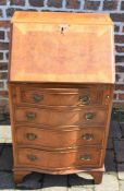 Small reproduction Georgian bureau with serpentine front (damage to veneer around the lock)