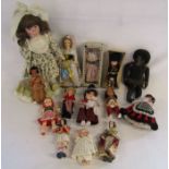 Collection of vintage dolls to include a black doll with grass skirt and national dress dolls