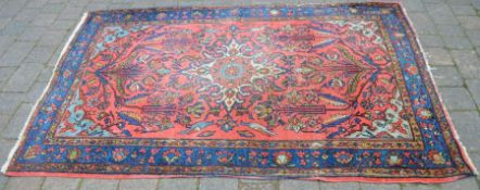 Red ground Persian rug 207cm by 135cm