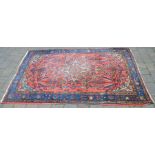 Red ground Persian rug 207cm by 135cm