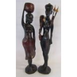 A pair of heavy wooden African tribal figures approx. 75cm tall