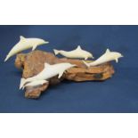 Five dolphins leaping on driftwood sculpture by John Perry