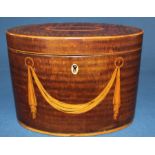 George III oval mahogany tea caddy with inlaid swag to front and geometric inlay to lid, ivory