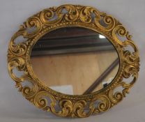 Ornate gilt frame wall mirror 57cm by 47cm