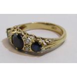 18ct diamond and dark sapphire ring - middle sapphire approx. 7mm - total weight 4.6g - ring size P
