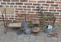 Pair of cast iron bench ends, watering can, propeller etc