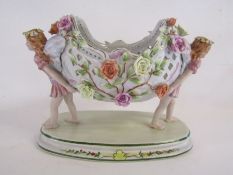 Meissen style fairies carrying a flower basket