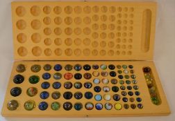 Wooden case containing glass marbles