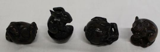 4 Japanese hardwood signed netsuke: - rat, rabbit, ox and fruit, all with signed mother of pearl