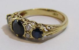 18ct diamond and dark sapphire ring - middle sapphire approx. 7mm - total weight 4.6g - ring size P