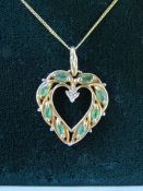 Cased 9k gold necklace with heart shaped pendant set with emeralds and diamond - total weight 2.4g