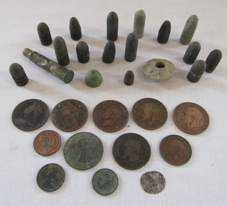 A collection of metal detecting finds to include weights, bullets and coins