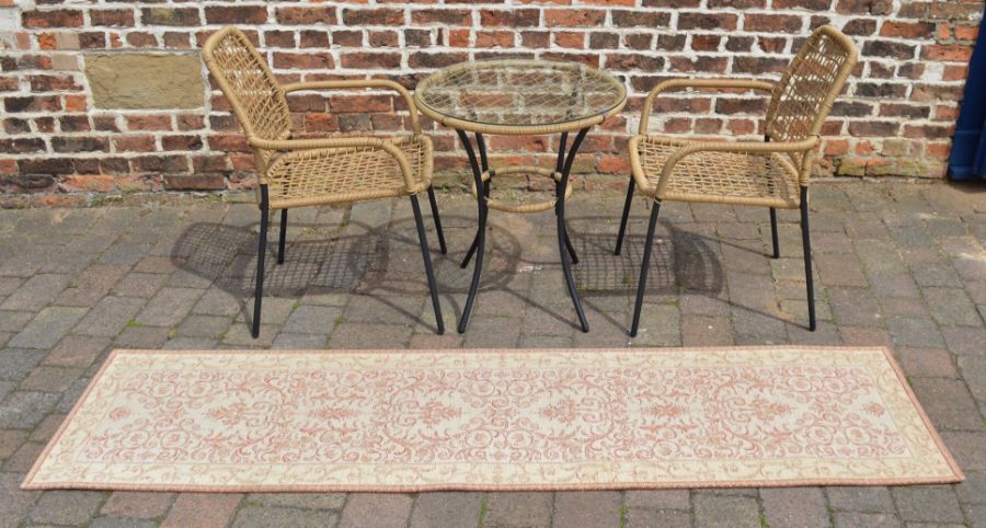 Glass top patio table with 2 chairs & a runner carpet