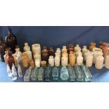 Large selection of salt glazed bottles, 2 large brown glass bottles & clear glass sauce bottles etc.