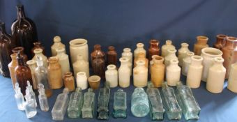 Large selection of salt glazed bottles, 2 large brown glass bottles & clear glass sauce bottles etc.