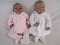 2 Reborn baby dolls 19" heavy weighted doll with dark painted hair and a front body plate and a