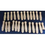 24 ( + 1 broken) cream bakelite stair carpet clips