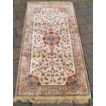 Small ivory ground cashmere rug with central lozenge medallion 143cm by 68cm