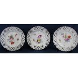 Three Meissen ribbon plates with hand painted floral decoration bearing the underglazed blue crossed