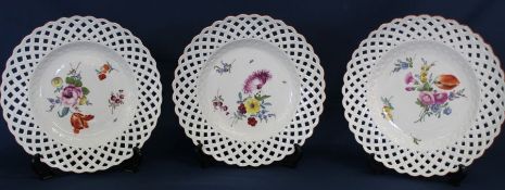 Three Meissen ribbon plates with hand painted floral decoration bearing the underglazed blue crossed