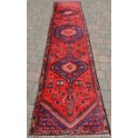 Red ground Persian Hamadan runner with medallion design 360cm by 76cm