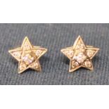 Pair of diamond star cluster earrings set in possibly platinum on gold posts