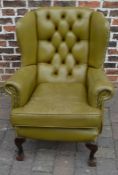 Button back armchair on ball & claw feet in olive green coloured leather