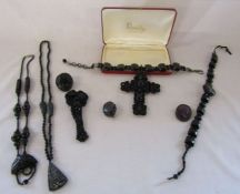 Collection of black jewellery including a large black choker with cross pendant with leather back,