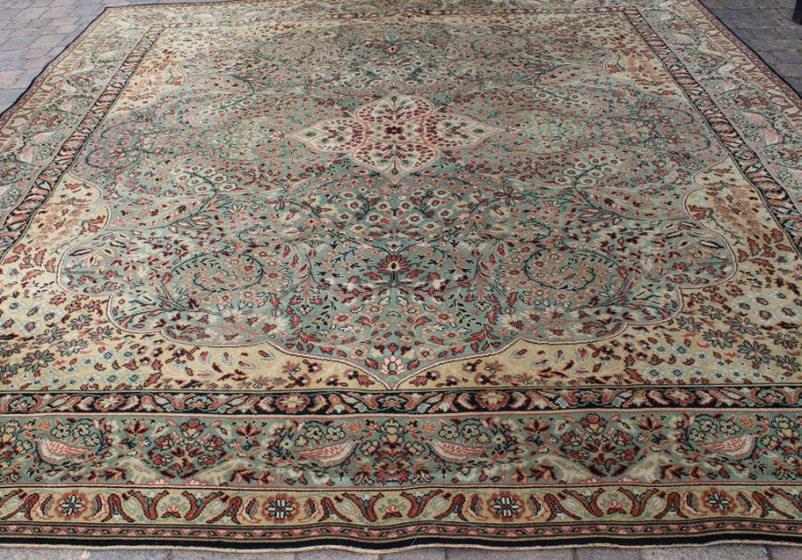 Large wool carpet on green ground 369cm x 318.5cm