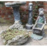 Selection of garden ornaments including a bird bath, lighthouse, rabbit & planter