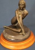 Bronze figure of a naked woman after Milo on circular wooden base 22cm high