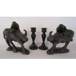 2 Chinese wooden hand carved water buffalo and a pair of ebonised candle sticks