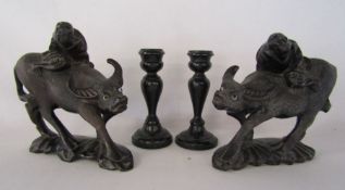 2 Chinese wooden hand carved water buffalo and a pair of ebonised candle sticks