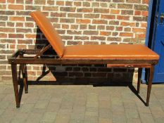 Re-upholstered early 20th century doctor's examination table with label Surgical Manufacturing Co