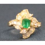 Diamond & emerald stylised ring marked 750 set with octagonal step cut emerald  0.75ct and 8