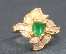 Diamond & emerald stylised ring marked 750 set with octagonal step cut emerald  0.75ct and 8