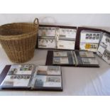 Wicker basket and 4 large folders of Royal Mail first day cover stamps
