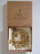 9ct gold charm bracelet with 18k gold cross and bird charm, 14ct gold heart with diamond charm and
