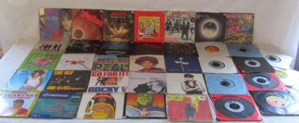 7" vinyl records including heavy metal by Whitesnake, Iron Maiden, Meat loaf, ACDC, printed black