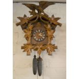 Ornately carved Swiss cuckoo clock (Height of clock 54cm)