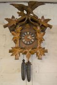 Ornately carved Swiss cuckoo clock (Height of clock 54cm)