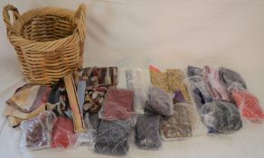 Various ties, scarves & handkerchiefs in a wicker basket