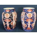 Pair of 19th century Imari pattern vases, 25cm high (some damage)