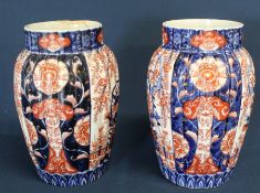 Pair of 19th century Imari pattern vases, 25cm high (some damage)