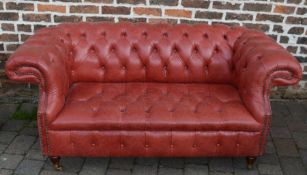 Red leather chesterfield two seater sofa, L170cm