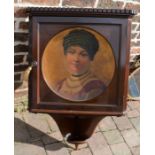 Early 20th century mahogany corner cupboard with portrait