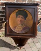 Early 20th century mahogany corner cupboard with portrait